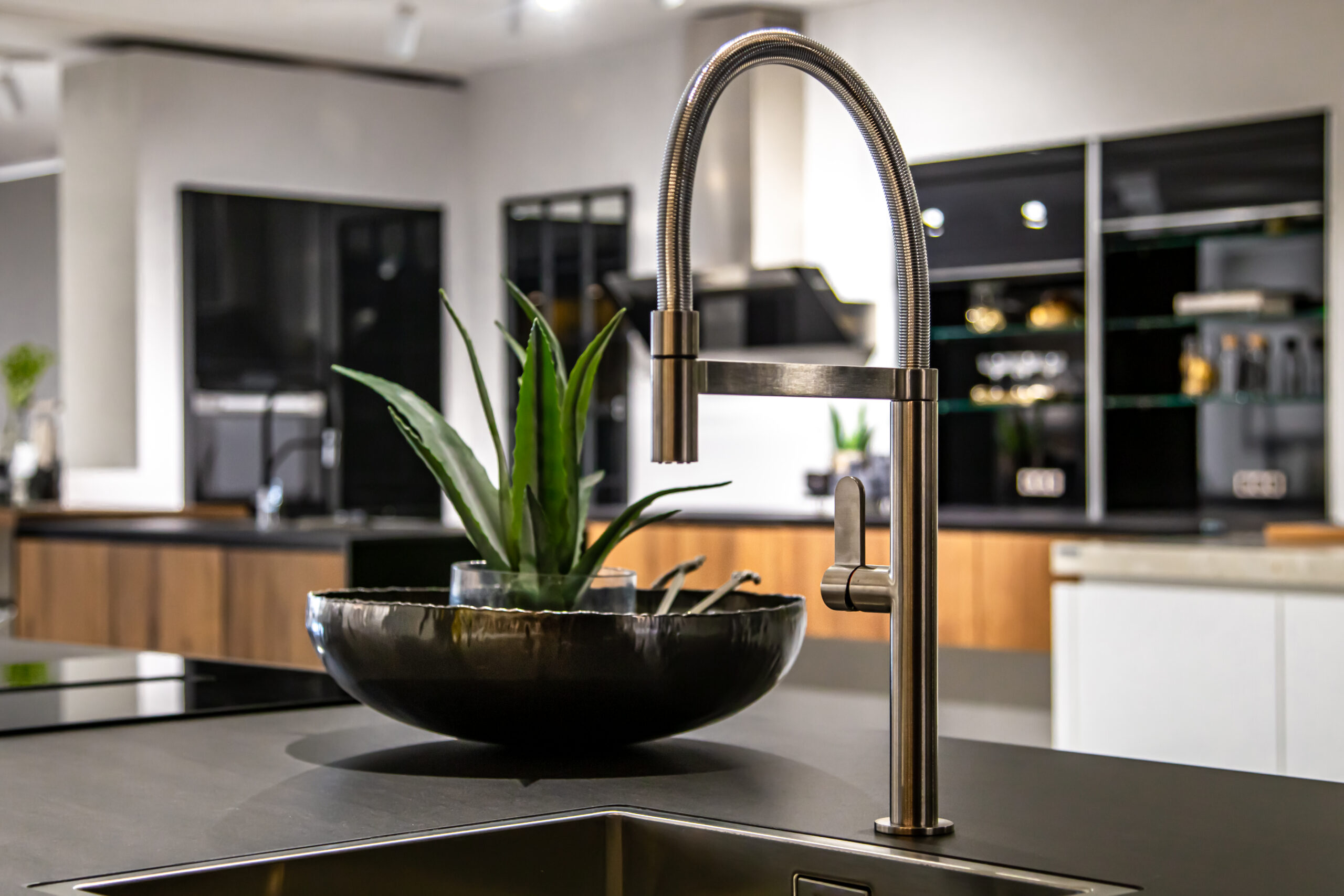 new modern steel faucet and kitchen room sink close up.